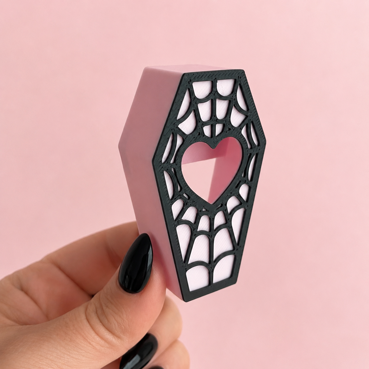 Back of magnetic coffin hide held in hand showing hidden magnetic design