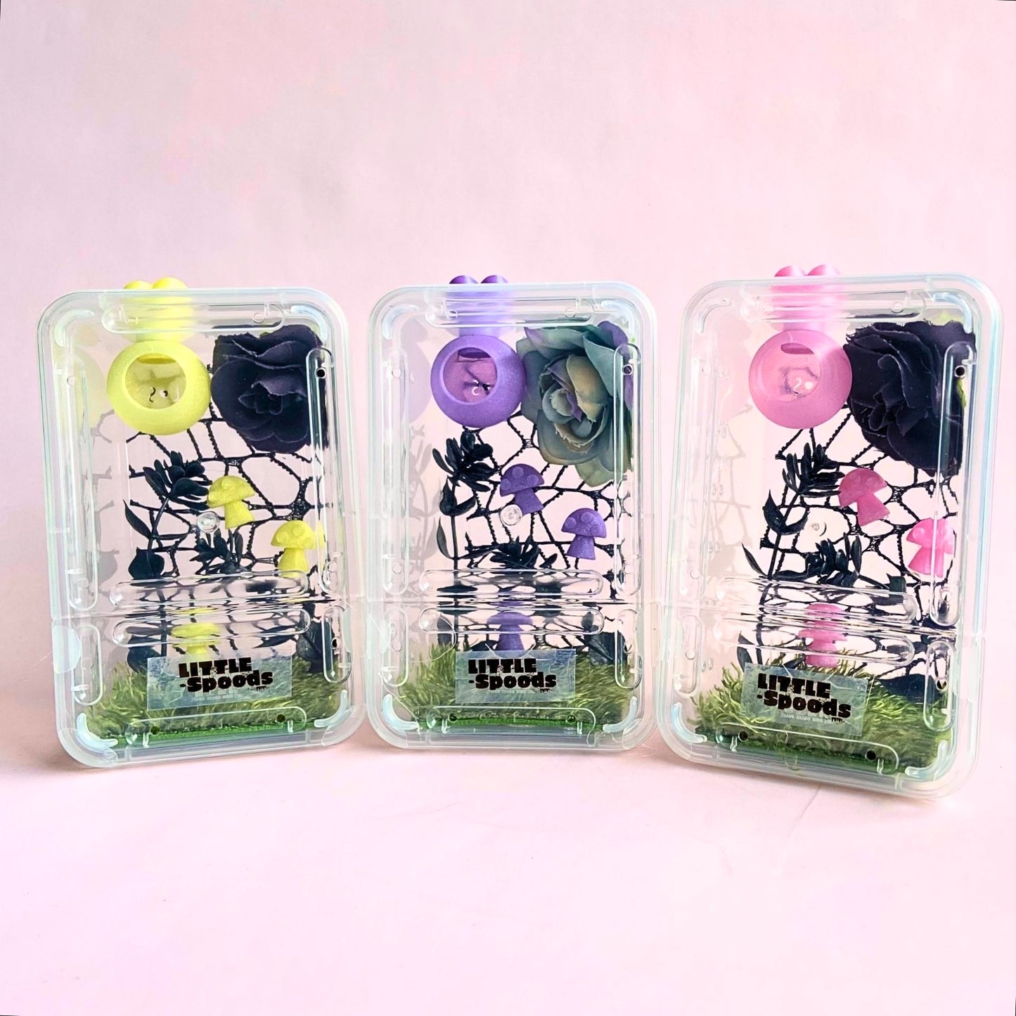 Decorated juvenile jumping spider enclosure available with pink, purple, and yellow decor featuring magnetic hide, flowers, mushrooms, and spider-safe décor