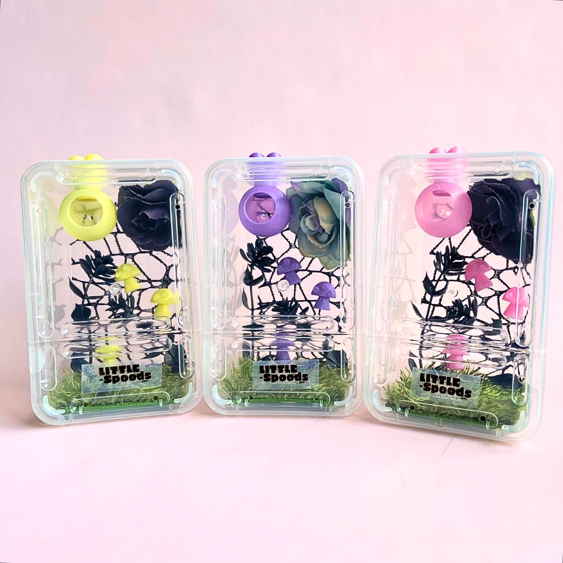 Decorated juvenile jumping spider enclosure available with pink, purple, and yellow decor featuring magnetic hide, flowers, mushrooms, and spider-safe décor