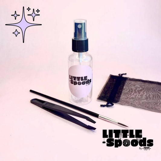 Jumping spider starter kit tools closeup – brush, tongs, spray bottle and pouch