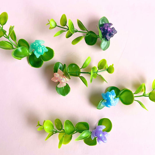 Magnetic jumping spider plant ledges in several colors with artificial greenery and glitter frog accents for enclosure decor