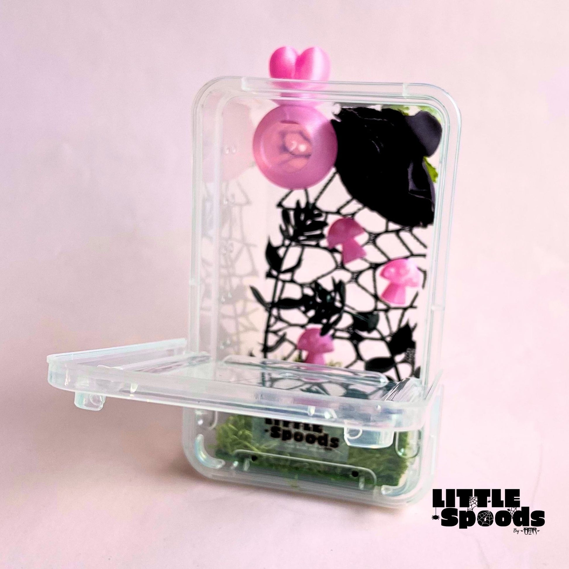 Pink juvenile jumping spider enclosure with front-opening door, magnetic hide, floral décor, and plenty of climbing space.