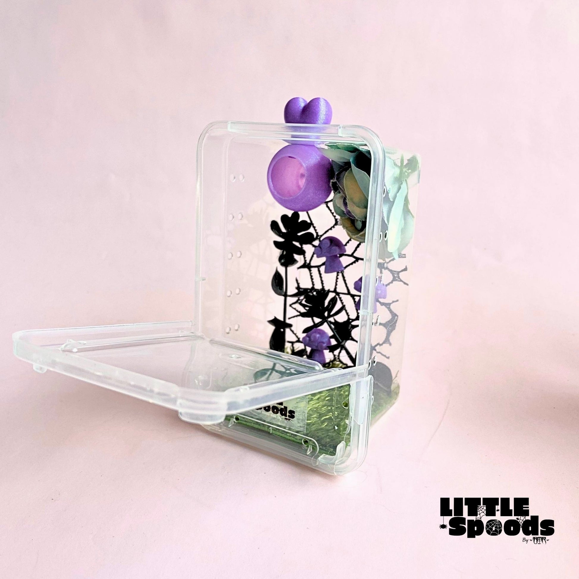 Purple handmade juvenile jumping spider enclosure with front-opening door, magnetic hide, flowers, mushrooms, and cross ventilation.