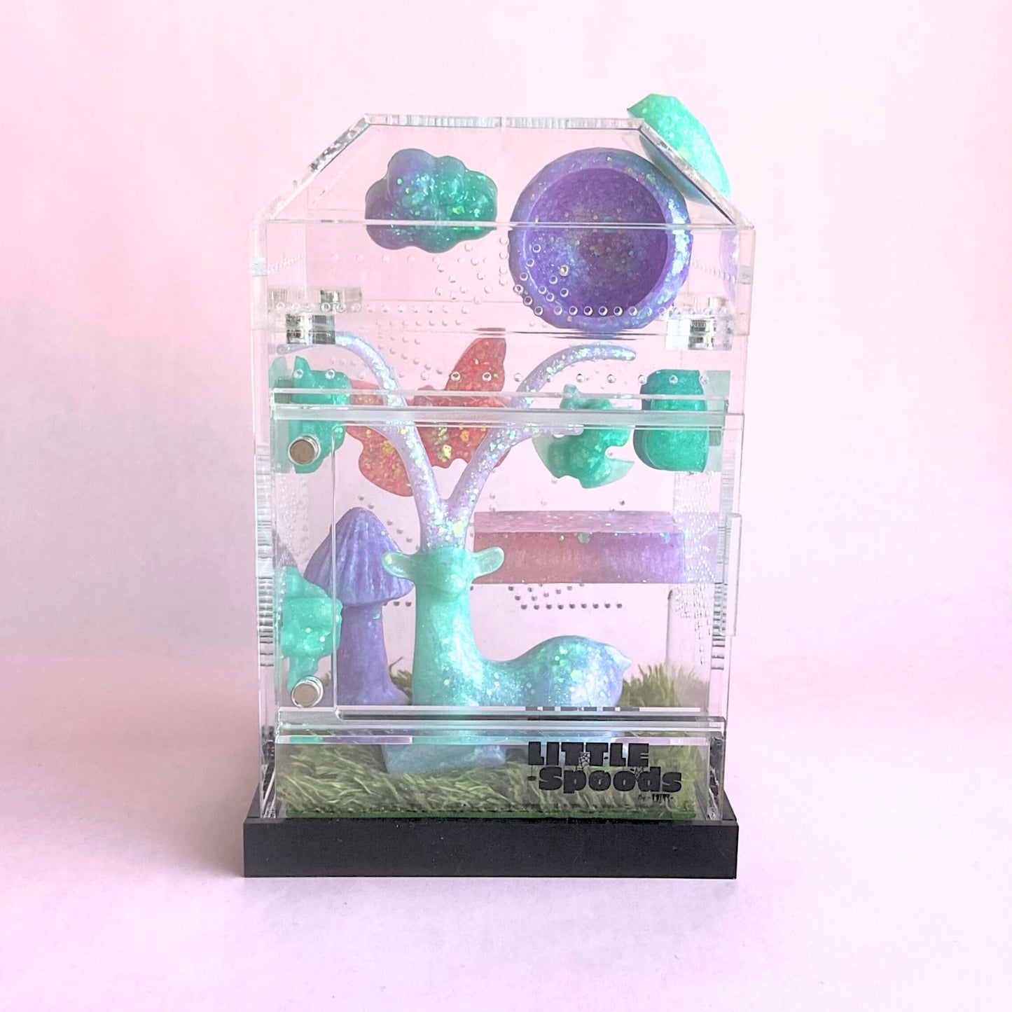 Whimsical themed Imaginarium jumping spider enclosure decorated in pink, green, and purple