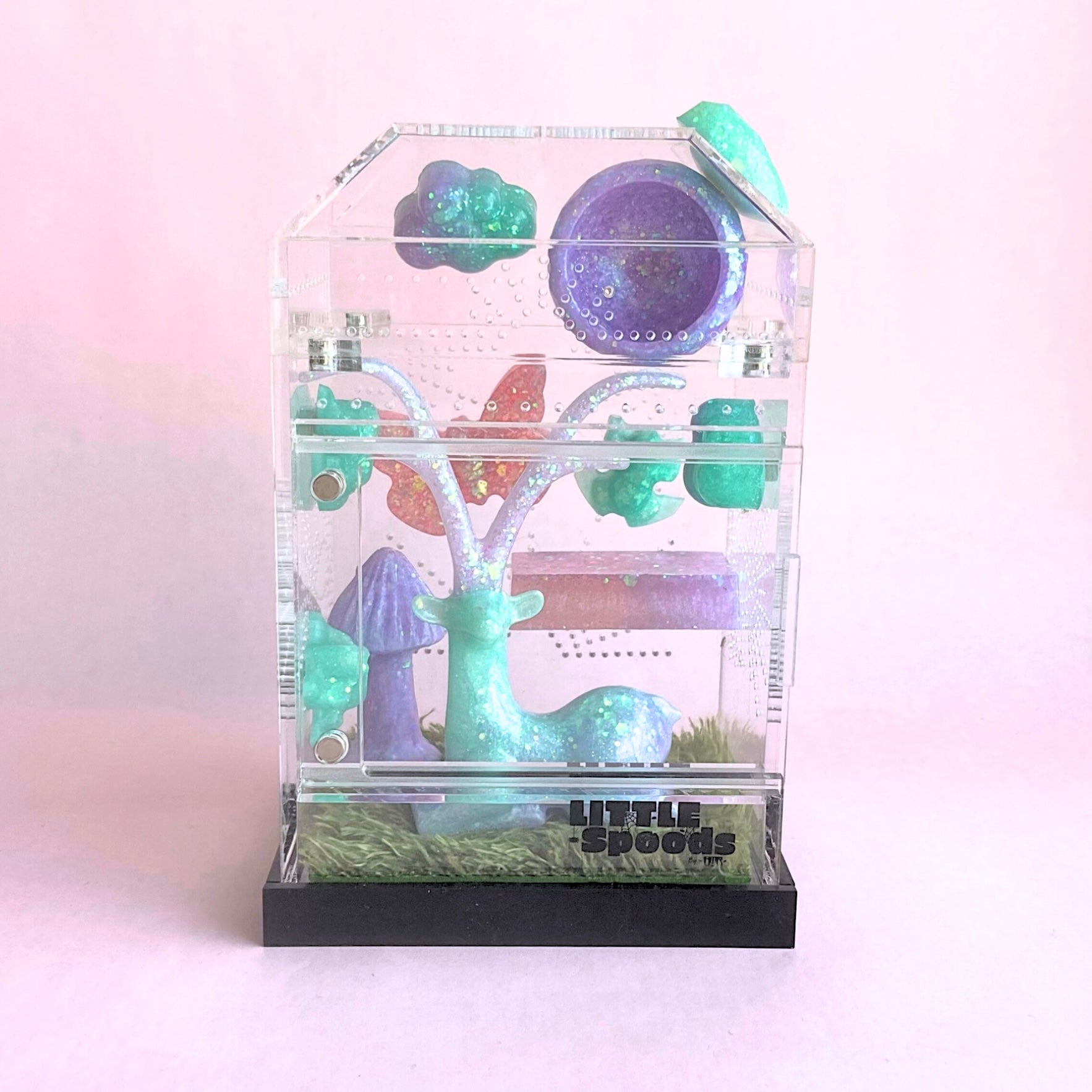 Whimsical themed Imaginarium jumping spider enclosure decorated in pink, green, and purple